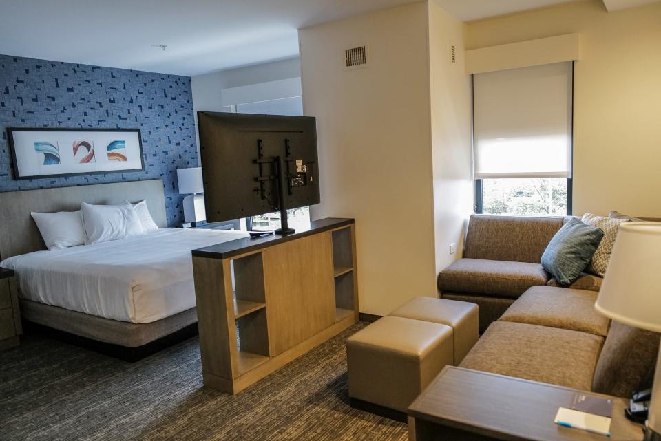 This is the bedroom and lounging area in the studio hotel room at the new Hyatt House in Lansing in the Red Cedar Development across from Frandor Tuesday, Aug. 22, 2023.