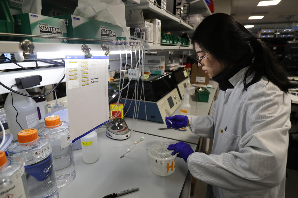 In this Jan. 14, 2020 photo, research associate Jessica Trinh of the Allen Institute in Seattle handles a piece of live brain tissue that was donated by Genette Hofmann who underwent brain surgery at Harborview Medical Center for epileptic seizures that had disrupted her life for decades. Trinh worked late into the evening to examine the tissue at a cellular level while it is still alive. As part of her surgery, Hofmann agreed to donate a small bit of her healthy brain tissue to researchers, joining a long line of epilepsy patients who've helped scientists reveal basic secrets of the brain. (AP Photo/Ted S. Warren)