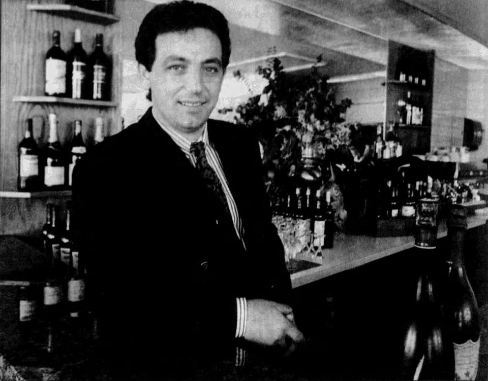 Casblanca Café Americain owner/host Nikki Stoupas stands at the restaurant's bar in 1992.