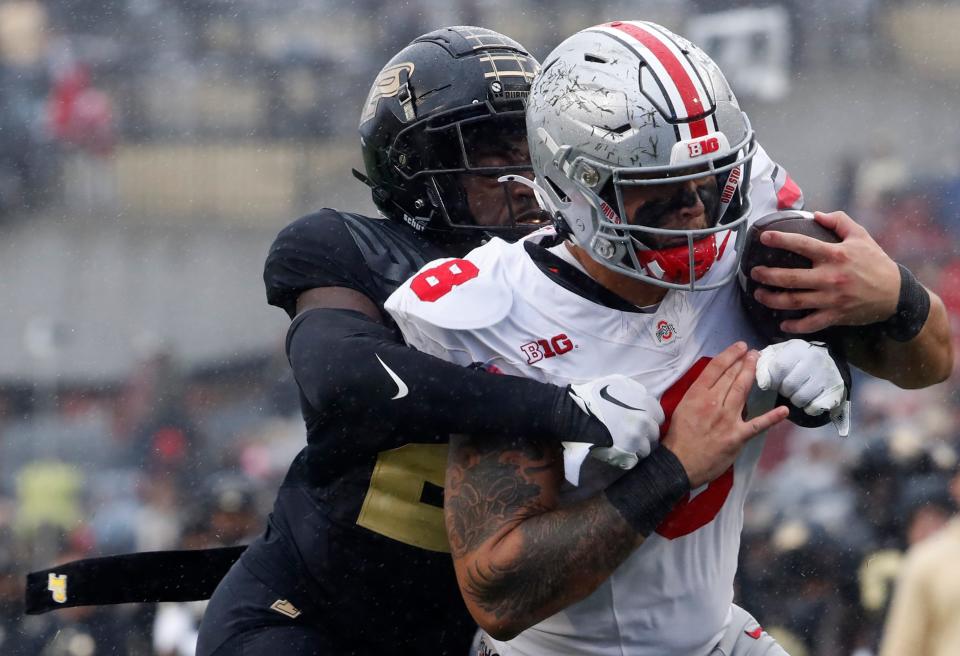 Purdue Boilermakers defensive back Sanoussi Kane (21) tackles Ohio State Buckeyes tight end Cade Stover (8) in the end zone during the NCAA football game, Saturday, Oct. 14, 2023, at Ross-Ade Stadium in West Lafayette, Ind. Ohio State Buckeyes won 41-7.