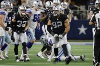 Las Vegas Raiders' Dallin Leavitt (32) and Solomon Thomas (92) celebrate after Thomas stopped Dallas Cowboys running back Ezekiel Elliott, bottom rear, on a running play in the second half of an NFL football game in Arlington, Texas, Thursday, Nov. 25, 2021. (AP Photo/Michael Ainsworth)