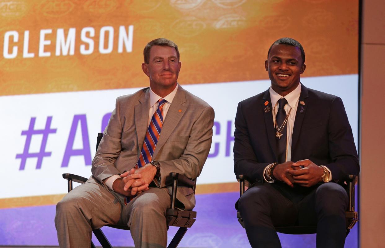 Clemson head coach Dabo Swinney, left, and Deshaun Watson, right, smiles as they listen to a question during a news conference at the Atlantic Coast Conference Football Kickoff in Charlotte, N.C., Friday, July 22, 2016. (AP Photo/Chuck Burton)