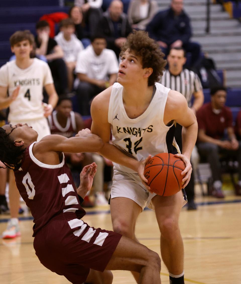 Sutherland’s Max Michalski fights through the tough defense by Aquinas’s Jadeir Breedlove.