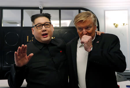 Howard X, an Australian impersonating North Korean leader Kim Jong Un, stands next to an impersonator of U.S. President Donald Trump at the La Paix Hotel in Hanoi, Vietnam February 25, 2019. REUTERS/Jorge Silva