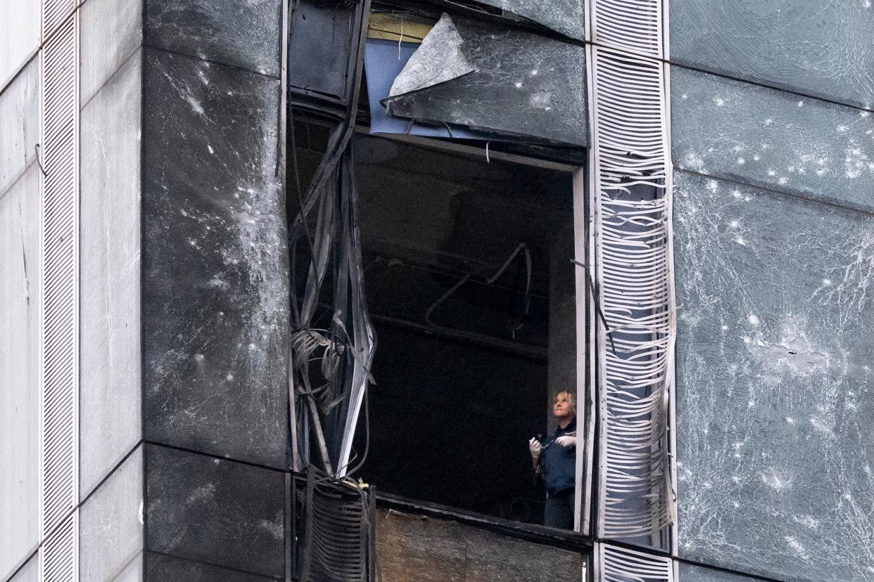 An investigator examines a damaged skyscraper in Moscow City business district (AP)