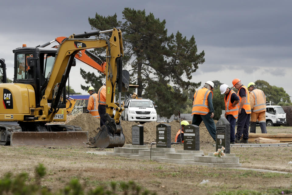 Workers dig graves at a Muslim cemetery in Christchurch, New Zealand, Saturday, March 16, 2019, for victims of a mass shooing at two area mosques. (AP Photo/Mark Baker)