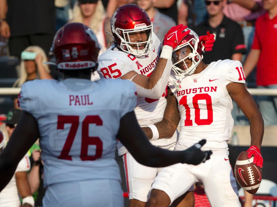 Houston's tight end Christian Trahan (85), left, and Houston's wide receiver Matthew Golden (10) celebrate GoldenÕs touchdown in the first overtime against Texas Tech, Saturday, Sept. 10, 2022, at Jones AT&T Stadium.