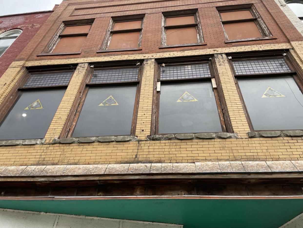 The four lavender and clear prism glass panel windows (top panels) in the former Monroe Optical building are shown and are a major part of the renovation project. The logo on the lower part of the window, after much research, was determined to be the logo of the McMillan Printing Co.