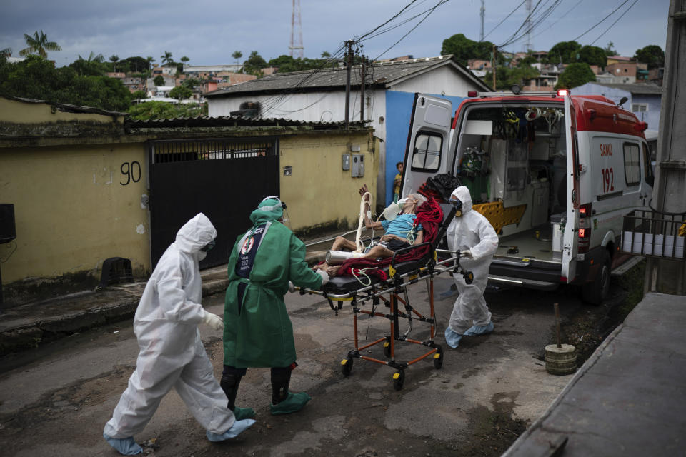 Emergency workers transfer an elderly patient, suspected of having COVID-19, to a hospital in Manaus, Brazil, Wednesday, May 13, 2020. Per capita, Manaus is Brazil's major city hardest hit by COVID-19. (AP Photo/Felipe Dana)