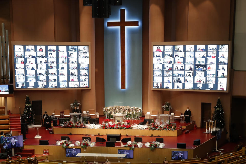 Christians on the screen attend an online Christmas service for social distancing and a precaution against the coronavirus at the Yoido Full Gospel Church in Seoul, South Korea, Friday, Dec. 25, 2020. (AP Photo/Lee Jin-man)