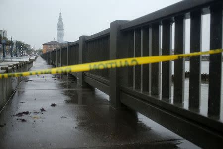 Police tape is pictured on the Embarcadero, which is closed due to the weather, in San Francisco, California December 11, 2014. REUTERS/Robert Galbraith