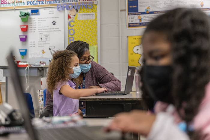 A teacher with a student in the classroom