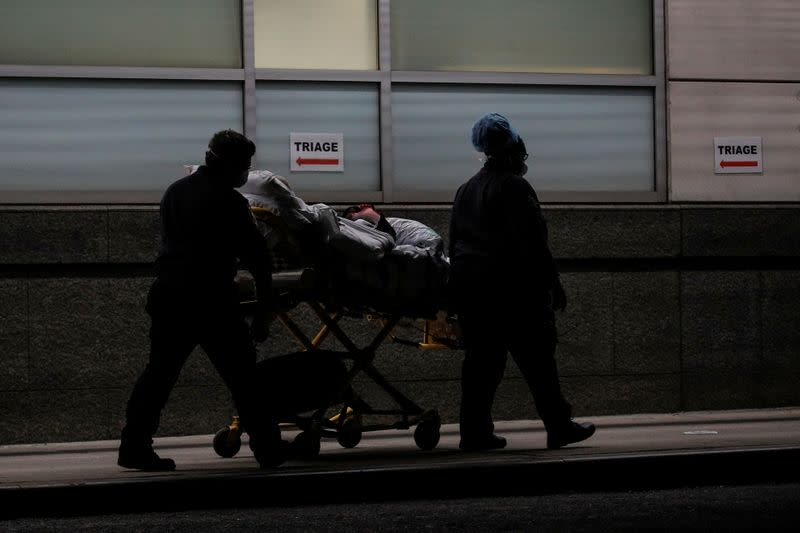 Paramedics bring a patient into the emergency center at Maimonides Medical Center during the outbreak of the coronavirus disease (COVID19) in the Brooklyn, New York