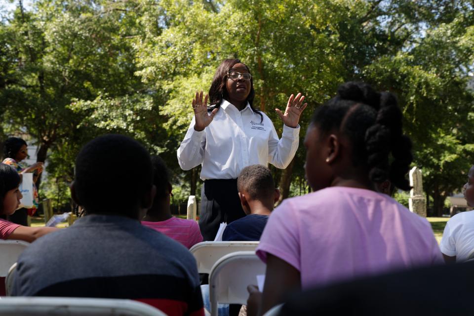 City Commissioner Dianne Williams-Cox talks with third graders from Riley Elementary School at the John G. Riley Museum Civil War commemorative grave decorating ceremony at Old City Cemetery to celebrate Emancipation Day Monday, May 20, 2019. 