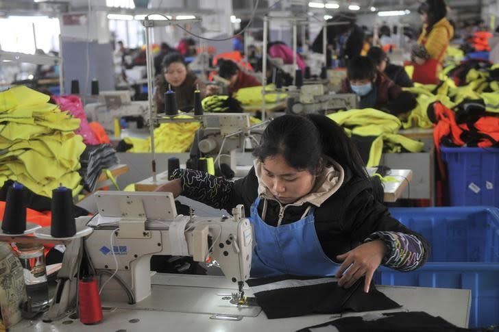 An employee works at a garment factory, which exports products to Europe, in Hefei, Anhui province January 19, 2015. REUTERS/Stringer/Files