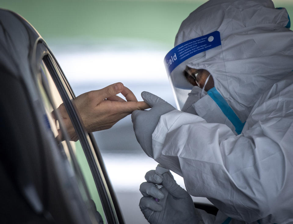 A health care worker prepares to administer a drive through antibody test at Belmont Medical Care in Franklin Square, N.Y. (Getty Images)