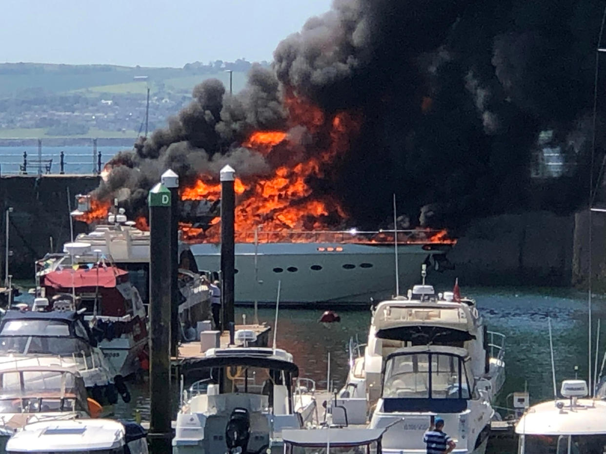 Roads had to be closed and beaches evacuated on Saturday as the blaze engulfed the yacht. (SWNS)