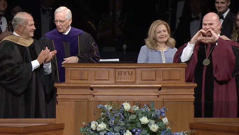 New BYU-Idaho President Alvin F. Meredith makes a heart sign next to his wife, Jennifer, after he was formally installed by Elders Ronald A. Rasband, left, and D. Todd Christofferson at the BYU-Idaho Center in Rexburg, Idaho, on Tuesday, Oct. 10, 2023.