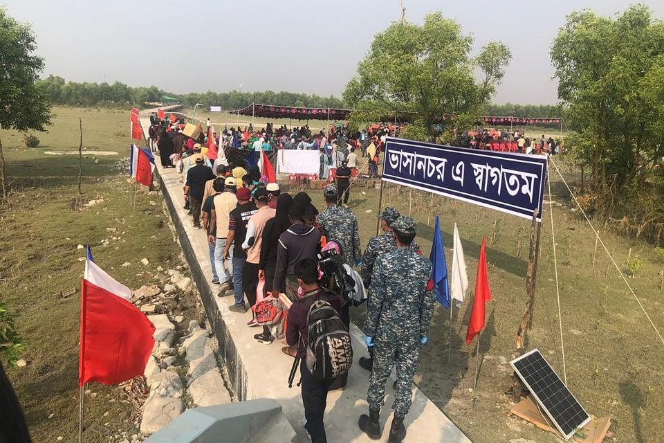 <p>Rohingya refugees stand in a queue after they disembarked from a Bangladesh Navy ship to the island of Bashar Char</p> (AFP via Getty Images)