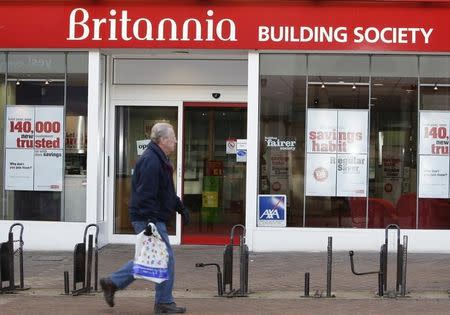 A pedestrian walks past the Britannia Building Society, in Northampton, central England January 21, 2009. REUTERS/Darren Staples