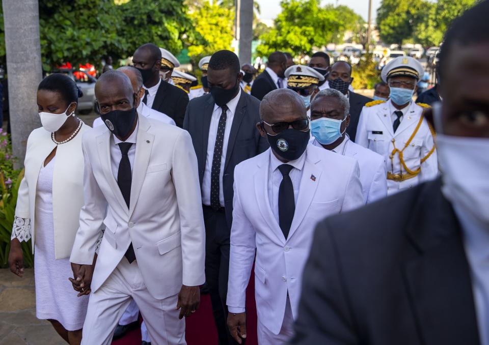 FILE - Haiti's President Jovenel Moïse, center left, holds hands with his wife Martine, as he walks with new prime minister Joseph Jouthe, right, before laying flowers to mark the death anniversary of revolutionary leader Jean-Jacques Dessalines, in Port-au-Prince, Haiti, in this Saturday, Oct. 17, 2020, file photo. Haitian Prime Minister Joseph Jouthe announced early Wednesday, April 14, 2021, that he has resigned as the country faces a spike in killings and kidnappings and prepares for an upcoming constitutional referendum and general election later this year. (AP Photo/Dieu Nalio Chery, File)
