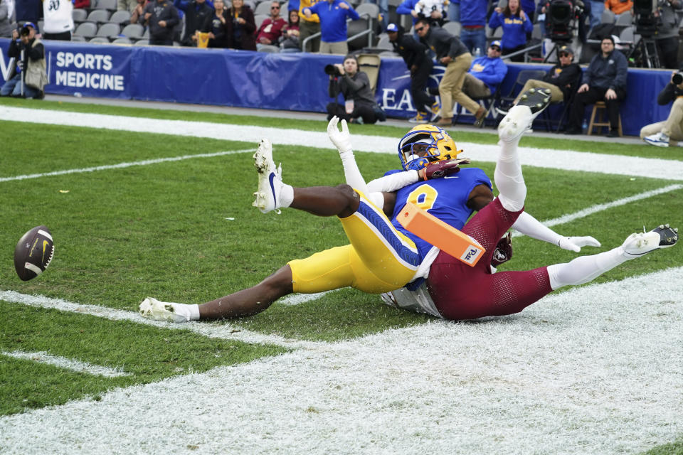 Florida State defensive back Fentrell Cypress II, bottom, forces a fumble against Pittsburgh wide receiver Konata Mumpfield (9) during the first half of an NCAA college football game in Pittsburgh, Saturday, Nov. 4, 2023. Florida State recovered the fumble in the end zone. (AP Photo/Matt Freed)