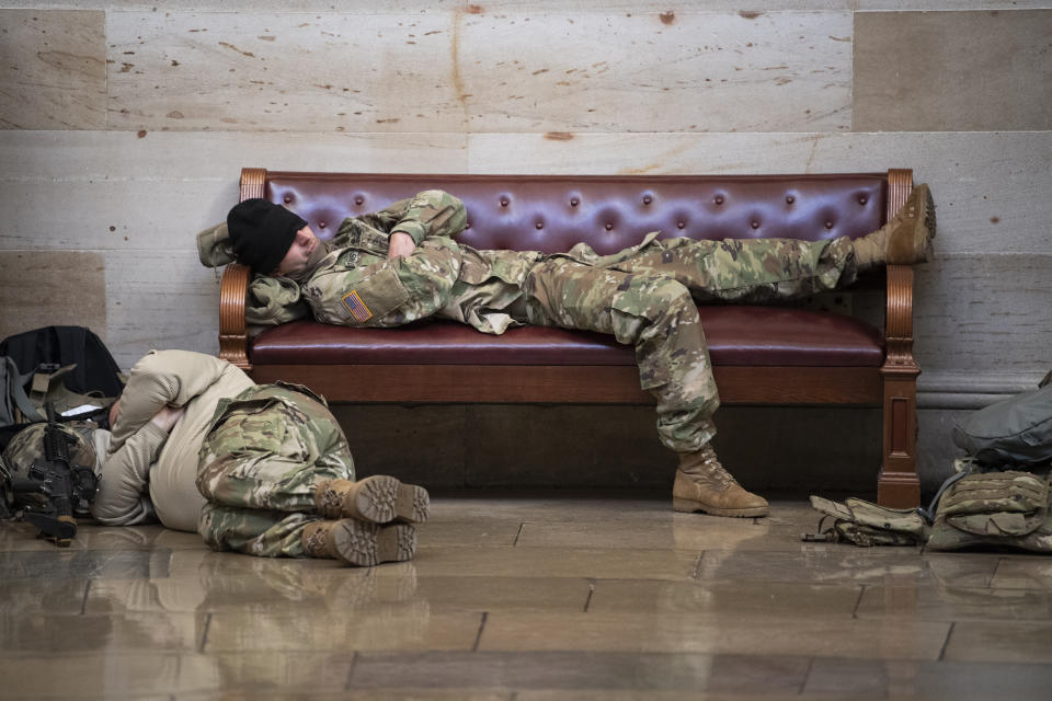 Members of the National Guard rest in the Rotunda of the Capitol 