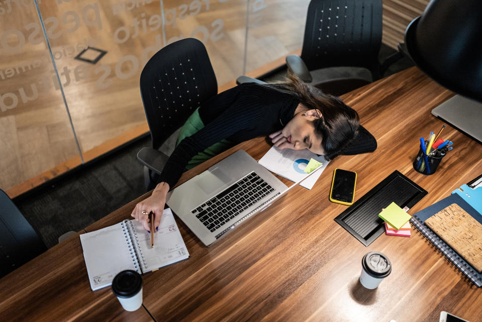 Exhausted businesswoman napping in the office