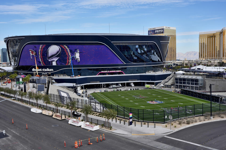 Workers prepare the field outside Allegiant Stadium ahead of Super Bowl 58, Wednesday, Jan. 31, 2024, in Las Vegas. (AP Photo/Matt York)