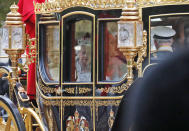 Britain's Queen Elizabeth II travels in a carriage to parliament for the official State Opening of Parliament in London, Monday, Oct. 14, 2019. (AP Photo/Frank Augstein)