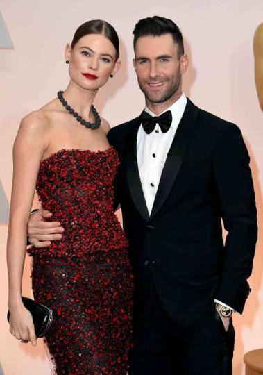Adam Levine (R) and Behati Prinsloo attend the 87th Annual Academy Awards at Hollywood &amp; Highland Center on February 22, 2015 in Hollywood, California