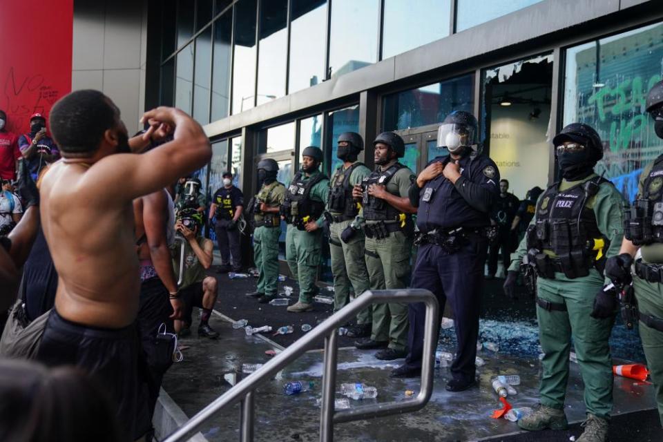 Police officers guard the CNN Center during a protest in Atlanta.