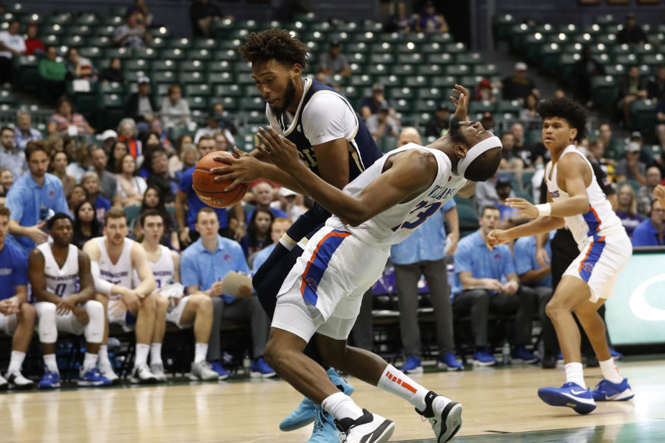 Boise State forward RJ Williams (23) draws an offensive foul from Georgia Tech forward James Banks III, left, during the first half of an NCAA college basketball game Sunday, Dec. 22, 2019, in Honolulu. (AP Photo/Marco Garcia)
