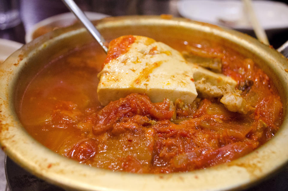 The<em> kimchi jigae</em> at Muk Eun Ji achieves a rare ruby red color and depth of flavor. 