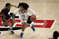 UCLA guard Tyger Campbell is defended by Pepperdine guard Darryl Polk Jr. during the second half of an NCAA college basketball game Friday, Nov. 27, 2020, in San Diego. (AP Photo/Gregory Bull)