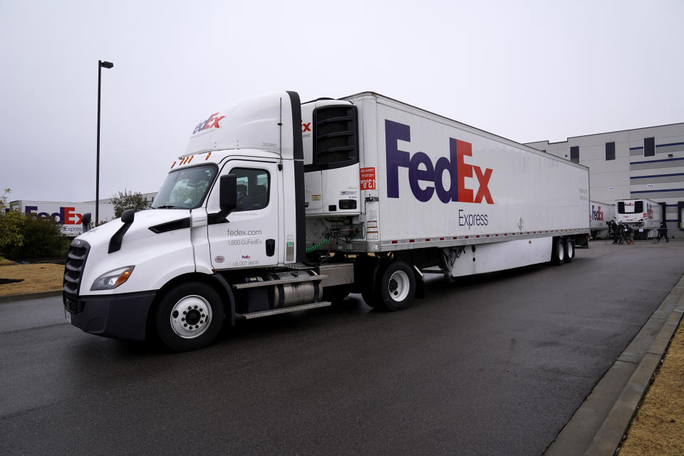 A FedEx truck loaded with boxes containing the Moderna COVID-19 vaccine leaves the McKesson distribution center in Olive Branch, Miss., Sunday, Dec. 20, 2020. (AP Photo/Paul Sancya, Pool)