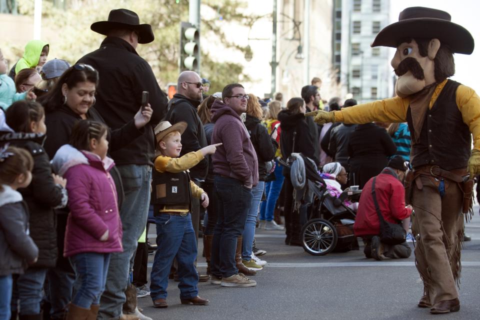 The University of Wyoming Cowboys’ mascot, Pistol Pete, points to Blane Ritter, 5, during the National Western Stock Show parade in Denver on Jan. 4, 2018. (Photo: Jason Connolly/AFP/Getty Images)