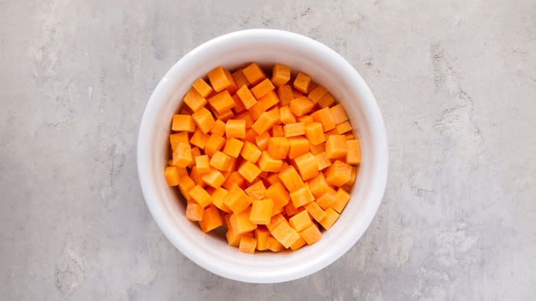 Diced carrots in white bowl