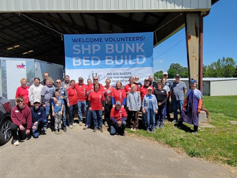 All April build-day volunteers from the local Columbia chapter of Sleep in Heavenly Peace, gather under their banner at Maury County Park on Saturday April 29, 2023. The nonprofit boasts more than 300 chapters nationwide, co-president Beth Morrill said.