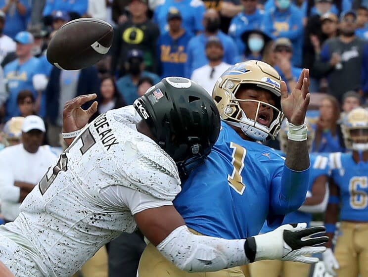 PASADENA, CALIF. - OCT. 23, 2021. UCLA quarterback Dorian Thompson-Robinson loses control of the ball.