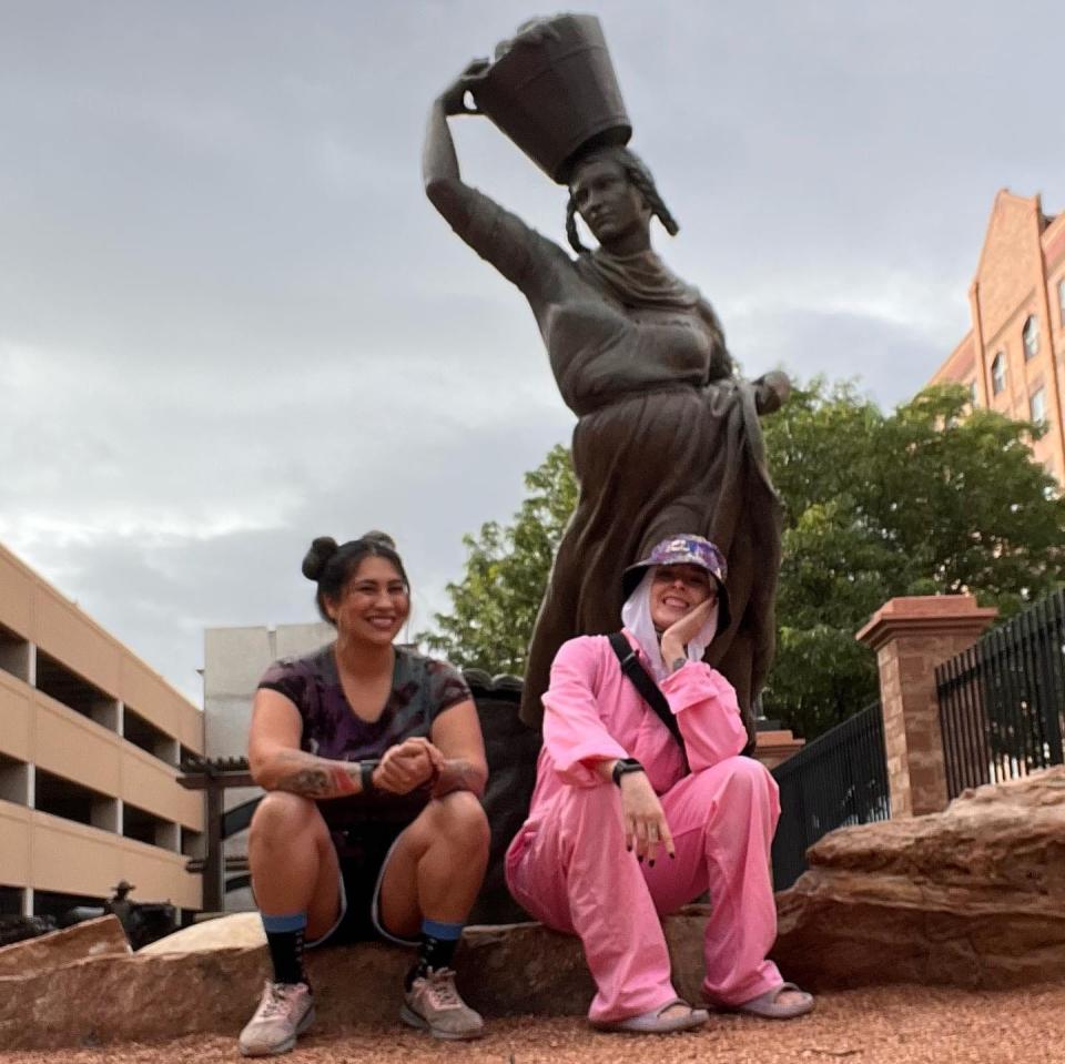 Local artists Desiree Talmich and Shannon Palmer next to the Teresita Sandoval statue at Pueblo's Walk of Legends