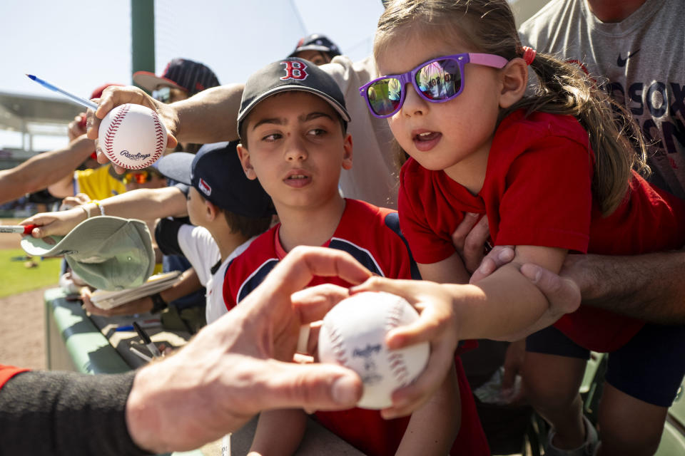 A young fan receives an autograph before the Red Sox vs. Twins spring training game.  (Billy Weiss/Boston Red Sox/Getty Images)