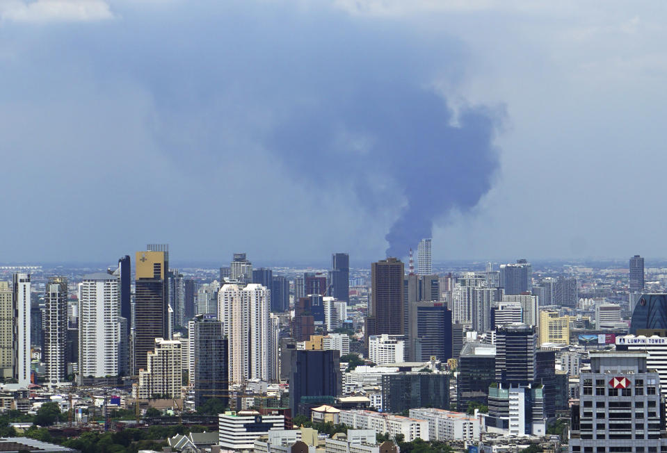 In a view from downtown Bangkok, giant plumes of smoke can be seen rising from the Samut Prakan province area in central Thailand, Monday, July 5, 2021. A massive explosion at a factory on the outskirts of Bangkok has shaken an airport terminal serving Thailand’s capital, damaged homes in the surrounding neighborhood, and prompted the evacuation of a wide area over fears of poisonous fumes from burning chemicals and the possibility of additional denotations. (Tina Liu via AP)