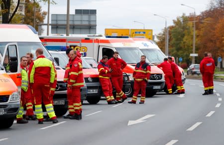 Paramedics stand next to ambulances near the site of a shooting in Halle