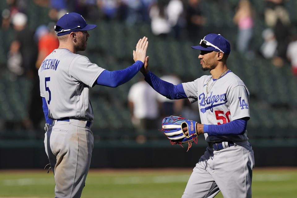 Los Angeles Dodgers' Freddie Freeman (5) and Mookie Betts celebrate the team's 11-9 win over the Chicago White Sox in a baseball game Thursday, June 9, 2022, in Chicago. (AP Photo/Charles Rex Arbogast)