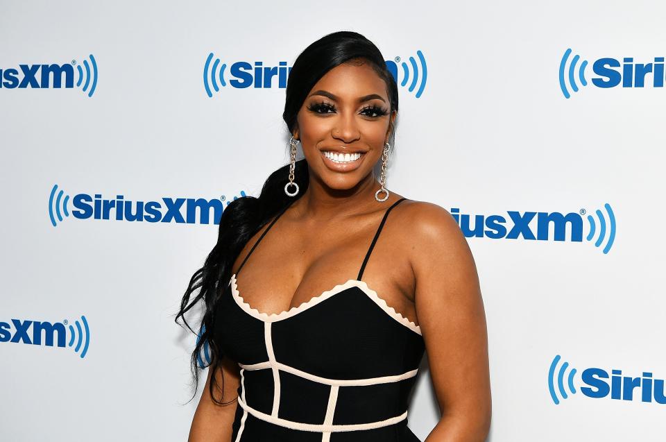 Porsha Williams looks fantastic in body-con black dress with white tapings