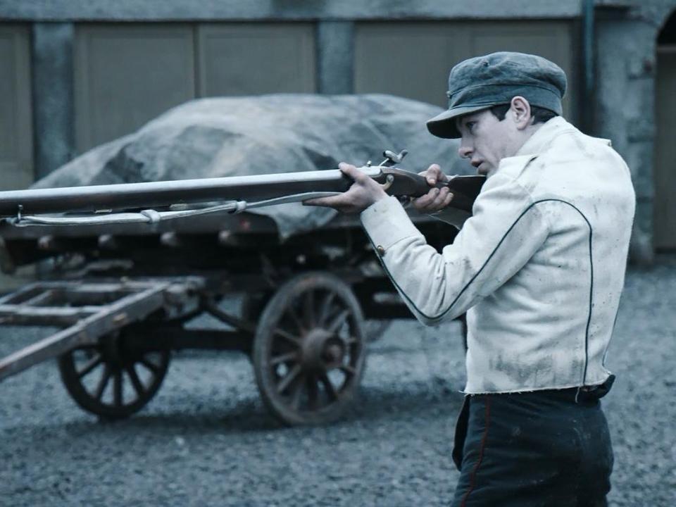 Barry Keoghan holding a musket gun