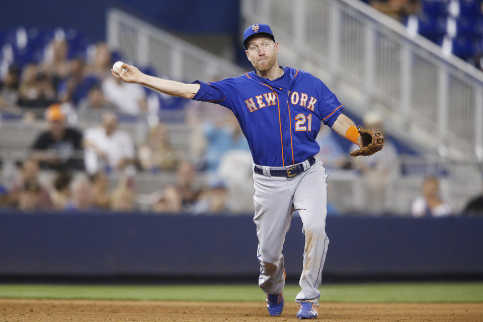 MIAMI, FLORIDA - JULY 13:  Todd Frazier #21 of the New York Mets throws out a runner at first base during a game against the Miami Marlins at Marlins Park on July 13, 2019 in Miami, Florida. (Photo by Michael Reaves/Getty Images)