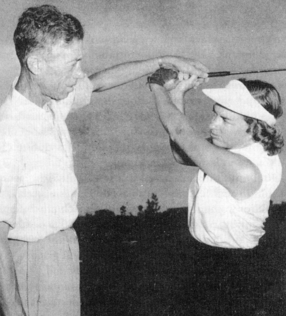 Betsy Rawls, right, receives instruction from legendary golf instructor Harvey Penick in this 1954 photo. Rawls, a four-time U.S. Women's Open champion, died Saturday at age 95. She leaves a lifetime impact on the LPGA.