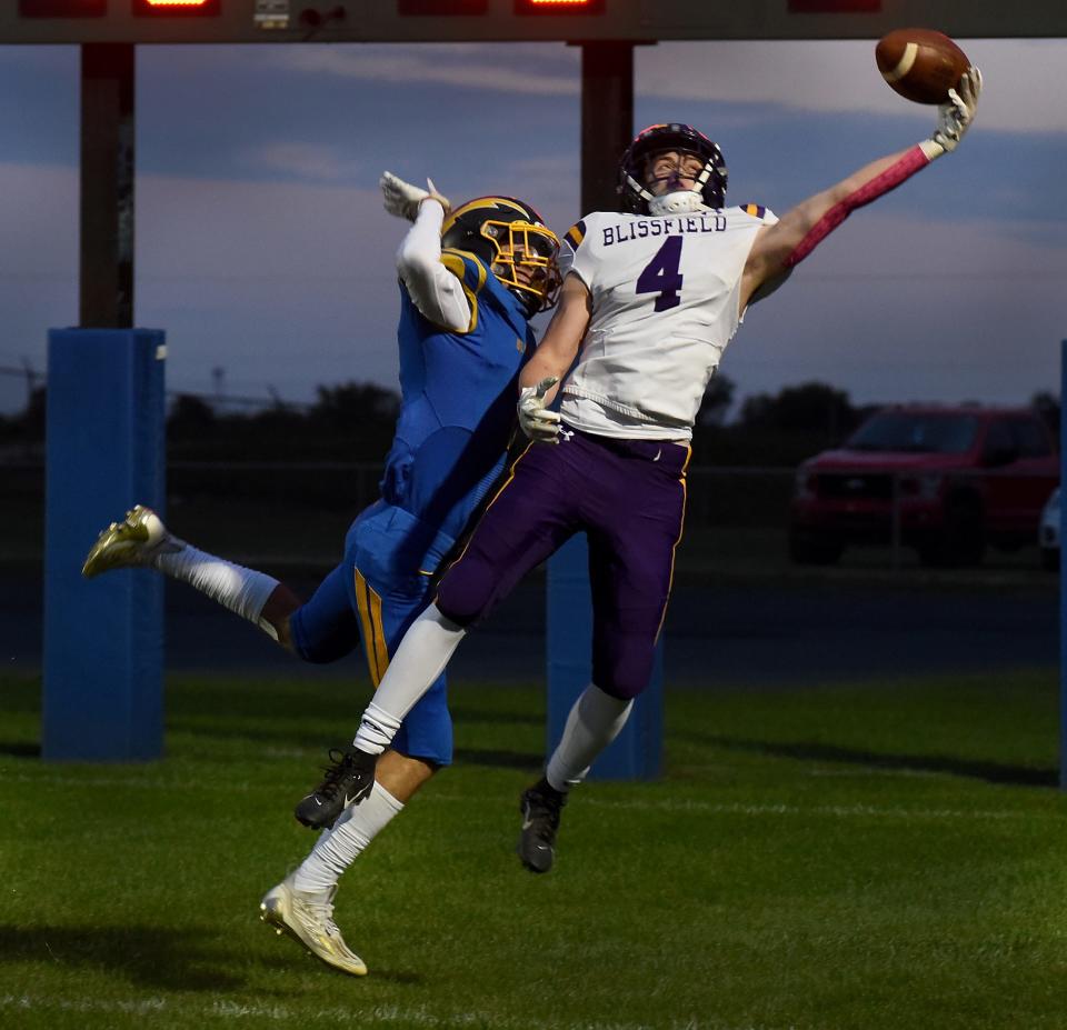 Mason Case of Blissfield makes an incredible touchdown catch as Jak Kocinski of Ida applied tight coverage Friday, October 6, 2023 in the first quarter at Ida.